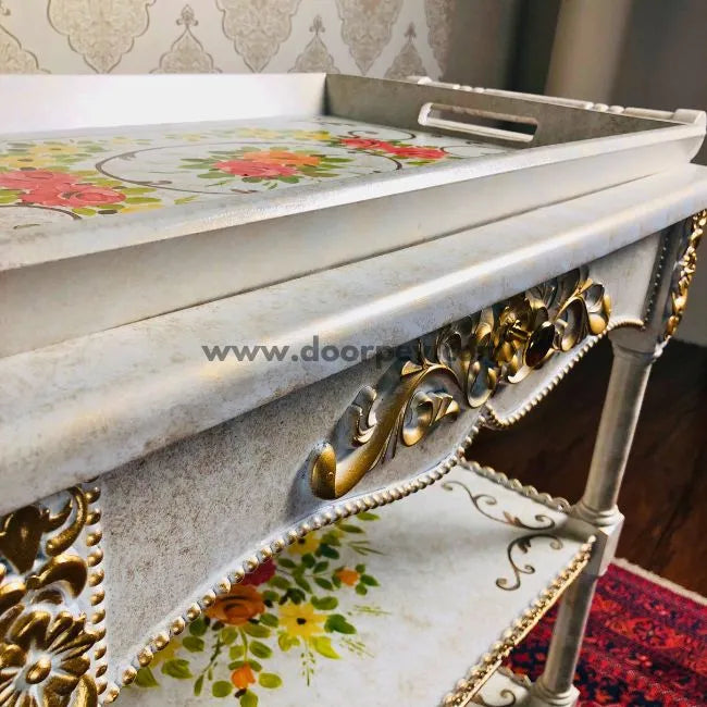 Close-up of hand-painted floral patterns on the Flower Burst wooden serving trolley.